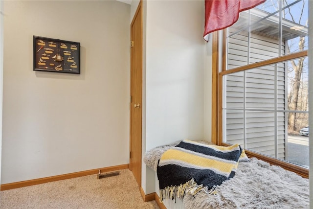 bedroom featuring visible vents, baseboards, and carpet