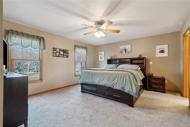 carpeted bedroom featuring baseboards and ceiling fan