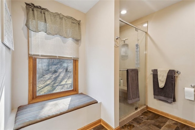 full bath featuring baseboards and a stall shower