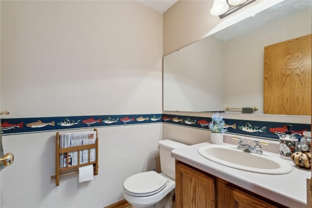 bathroom with toilet and vanity