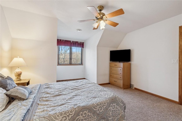 bedroom featuring baseboards, light colored carpet, a ceiling fan, and vaulted ceiling