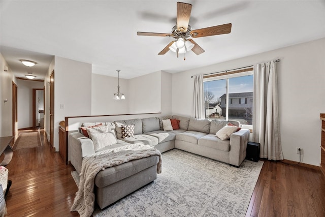 living area with baseboards, ceiling fan, and wood-type flooring