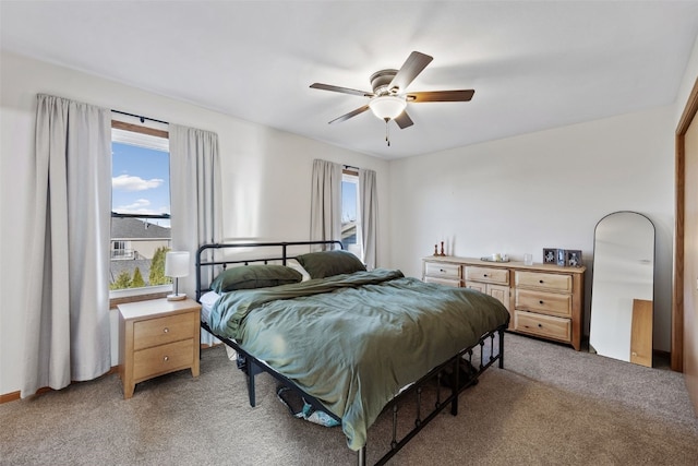 bedroom featuring a ceiling fan and light colored carpet