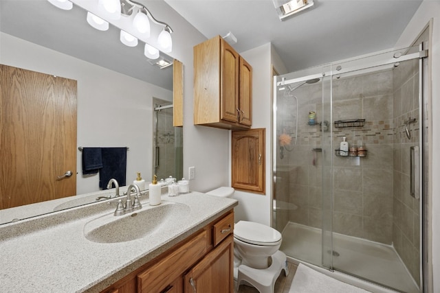 full bath featuring a stall shower, toilet, and vanity