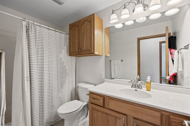 bathroom featuring curtained shower, toilet, and vanity