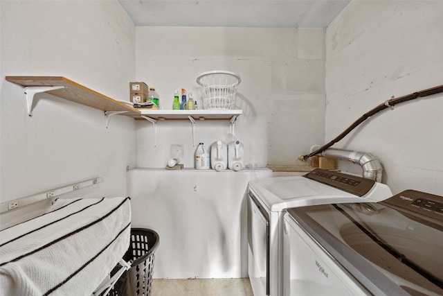 laundry area featuring separate washer and dryer, laundry area, and light wood finished floors