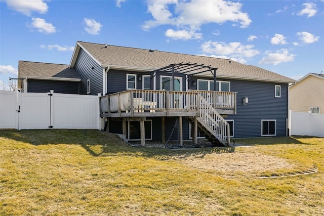 rear view of house with a lawn, a deck, a pergola, a fenced backyard, and stairway