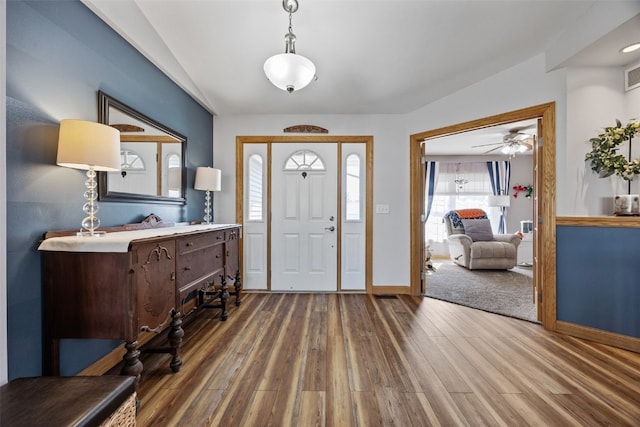 entryway featuring a ceiling fan, wood finished floors, visible vents, and baseboards