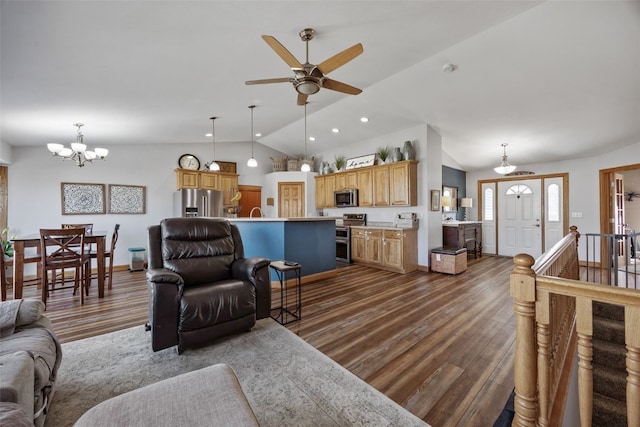 living room with recessed lighting, ceiling fan with notable chandelier, dark wood-type flooring, and vaulted ceiling