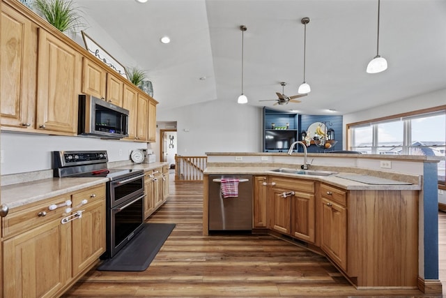 kitchen with a sink, light countertops, wood finished floors, and stainless steel appliances