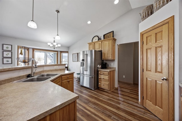 kitchen with dark wood finished floors, an inviting chandelier, a sink, vaulted ceiling, and high end refrigerator