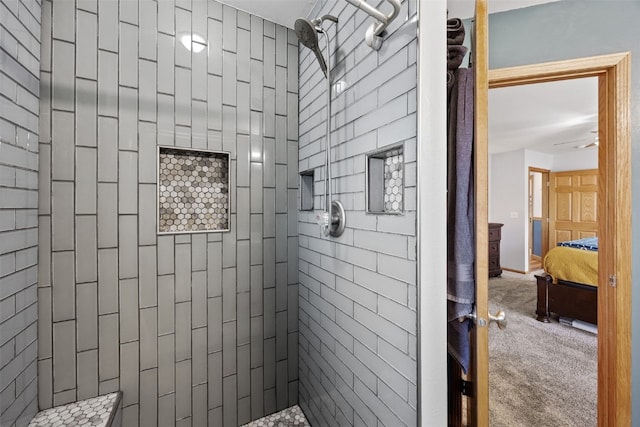 full bath featuring ceiling fan and a tile shower