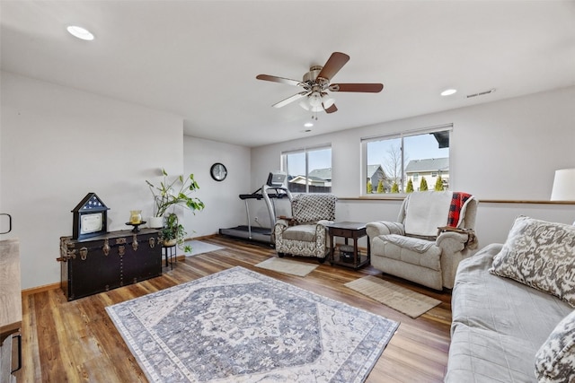 living area with recessed lighting, wood finished floors, visible vents, and ceiling fan