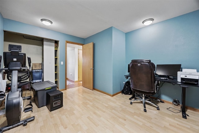 office area featuring baseboards and wood finished floors