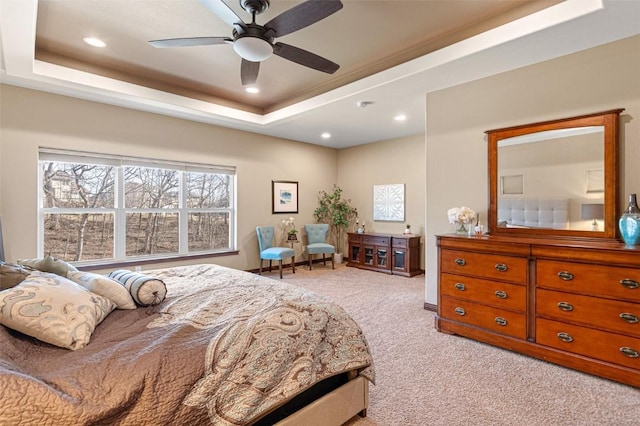 carpeted bedroom with recessed lighting, a tray ceiling, and ceiling fan