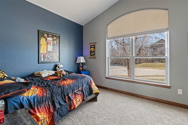 bedroom featuring baseboards, lofted ceiling, and carpet floors