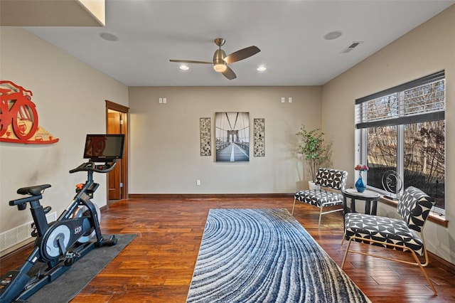 exercise room with visible vents, baseboards, ceiling fan, and wood finished floors