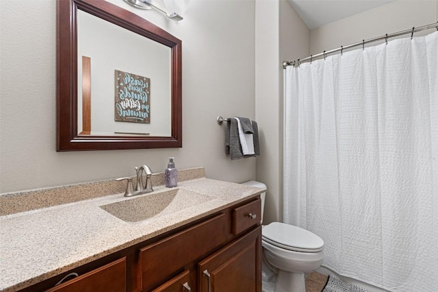 bathroom with vanity, curtained shower, and toilet