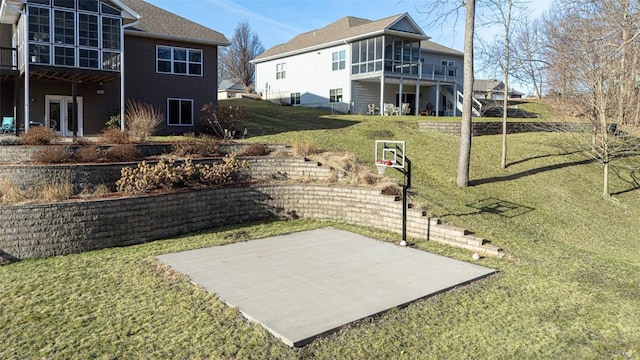 view of sport court featuring basketball court and a yard