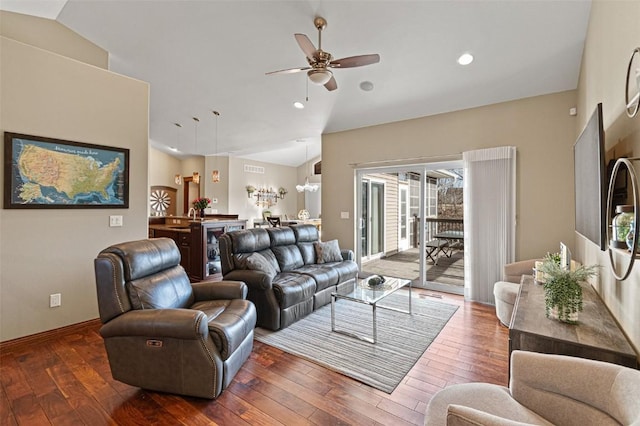 living area featuring lofted ceiling, a ceiling fan, and hardwood / wood-style flooring