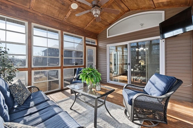 sunroom featuring wood ceiling, a ceiling fan, and vaulted ceiling