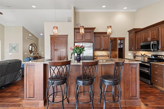 kitchen with visible vents, stainless steel appliances, open floor plan, and dark wood-style flooring