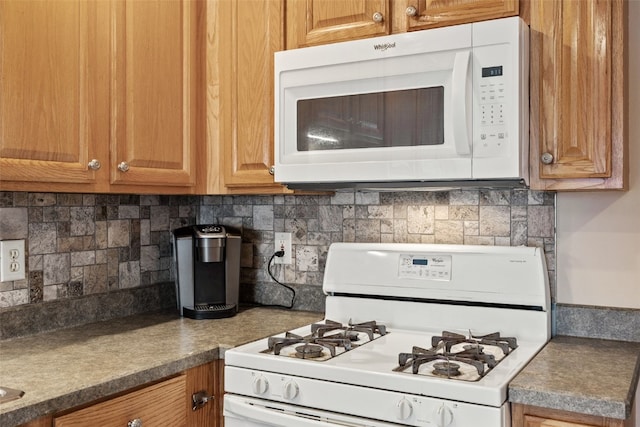 kitchen with white appliances and tasteful backsplash