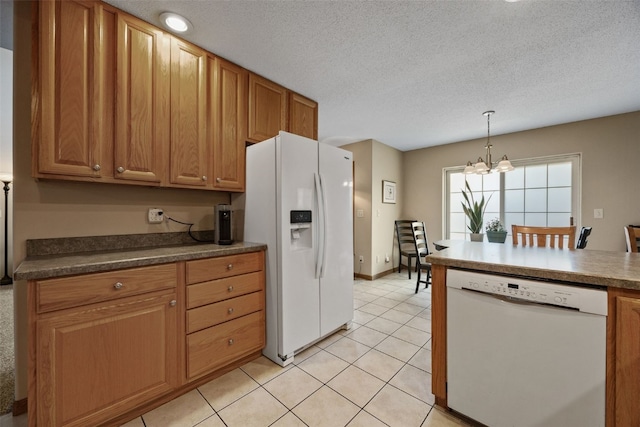 kitchen with white appliances, light tile patterned flooring, dark countertops, and a textured ceiling