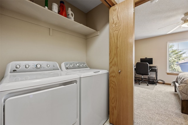 clothes washing area with baseboards, laundry area, ceiling fan, light carpet, and washing machine and dryer