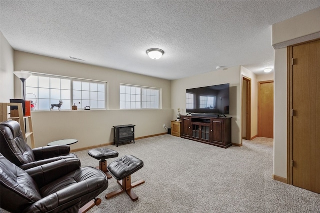 living area with visible vents, a wood stove, baseboards, and carpet floors