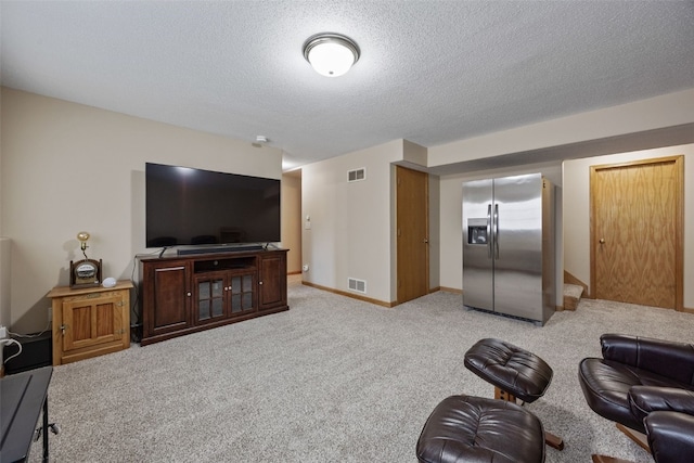 living room with light carpet, visible vents, a textured ceiling, and baseboards