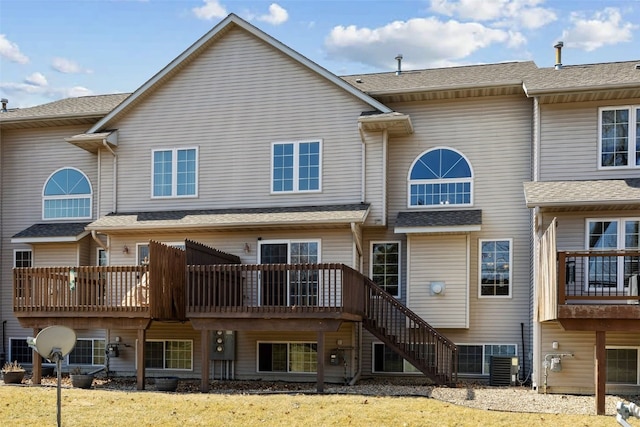 back of property featuring stairway and central AC