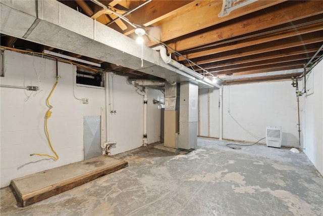 unfinished basement featuring heating unit