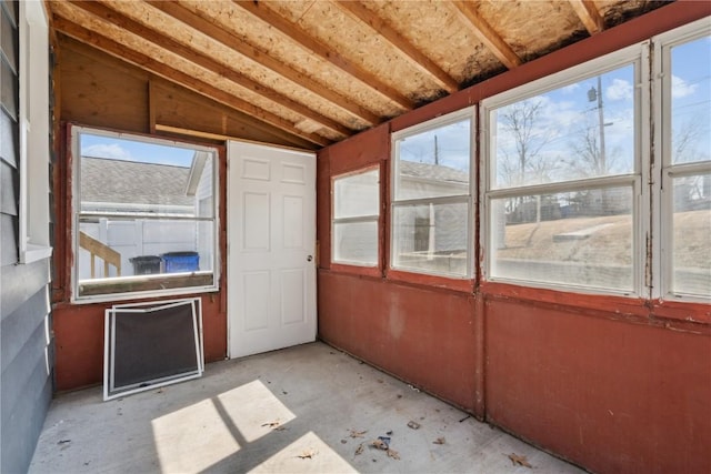 unfurnished sunroom featuring lofted ceiling