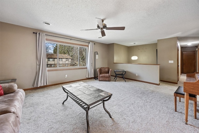 living area featuring carpet flooring, visible vents, baseboards, and a ceiling fan