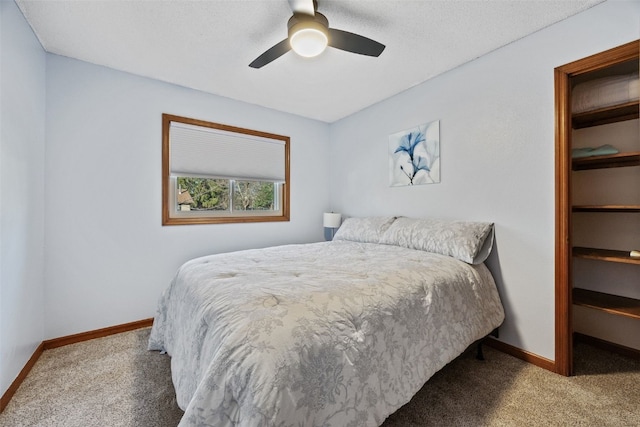 carpeted bedroom with baseboards and a ceiling fan