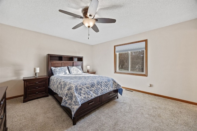 bedroom with a textured ceiling, baseboards, and light carpet