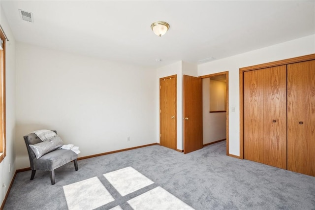 unfurnished room featuring baseboards, visible vents, and carpet floors