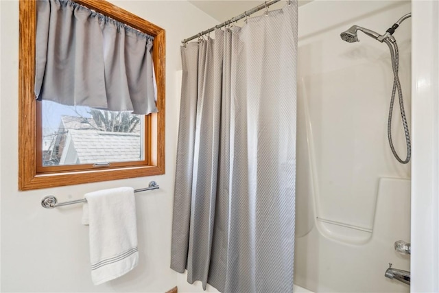 bathroom featuring shower / tub combo with curtain