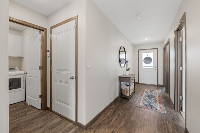 hallway featuring dark wood finished floors, washer / clothes dryer, and baseboards