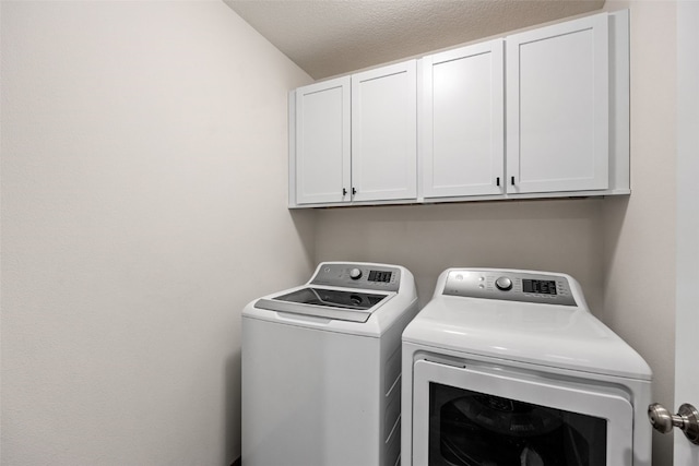 washroom with cabinet space and separate washer and dryer