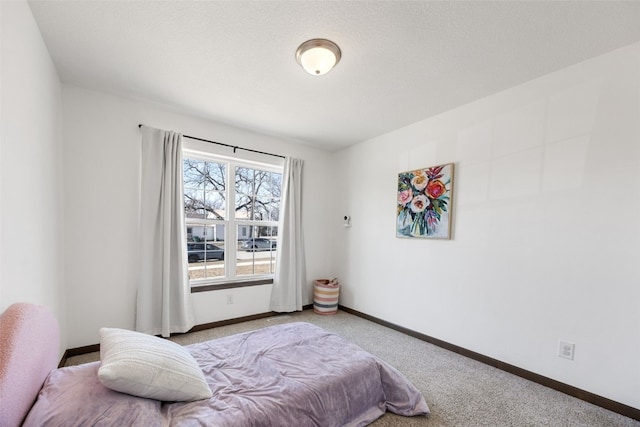 bedroom with carpet flooring and baseboards