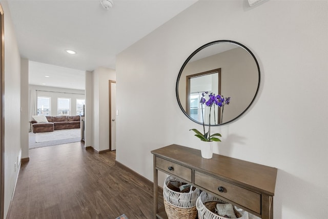 corridor featuring dark wood finished floors, recessed lighting, and baseboards