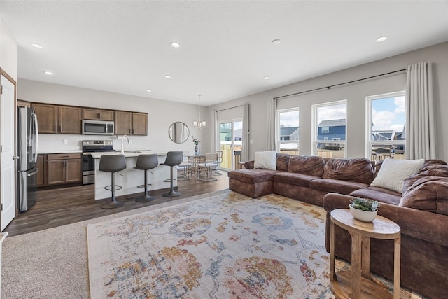 living room with recessed lighting and dark wood-style flooring