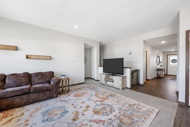 living area with recessed lighting, baseboards, and wood finished floors