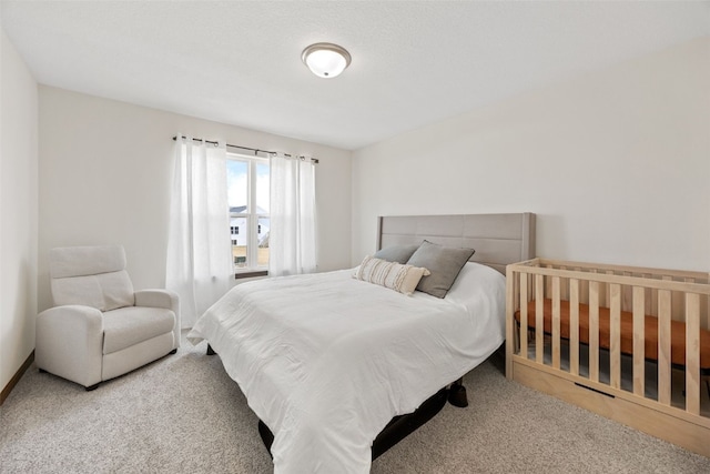 bedroom featuring baseboards and carpet floors