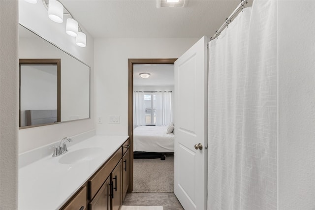 bathroom featuring visible vents, ensuite bathroom, a textured ceiling, a shower with shower curtain, and vanity