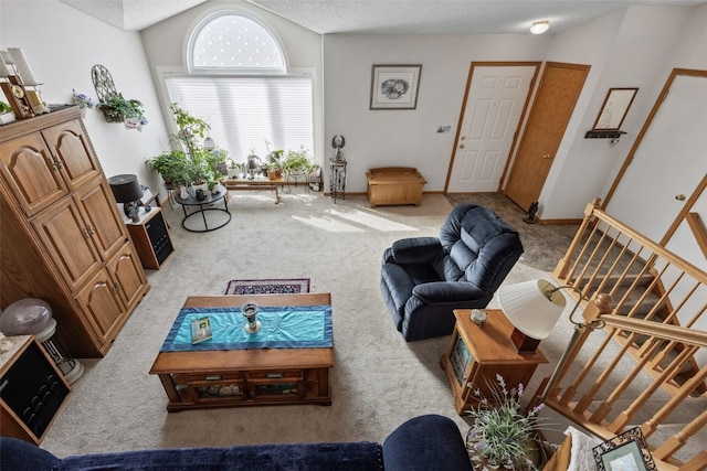 living area featuring baseboards, carpet floors, lofted ceiling, stairs, and a textured ceiling