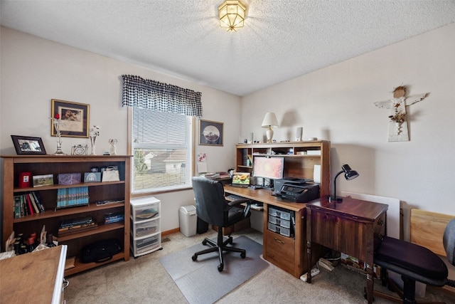 carpeted office featuring a textured ceiling and baseboards