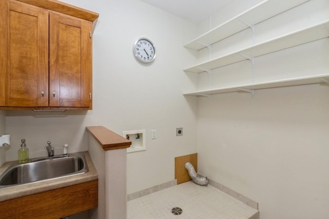 laundry room with a sink, cabinet space, tile patterned flooring, hookup for an electric dryer, and hookup for a washing machine